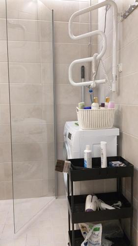 a bathroom with a shower with a toilet and a shelf at Apartment Kivistö, 2 km from centrum, free wifi and parking, no smoking, non-allergenic in Jyväskylä