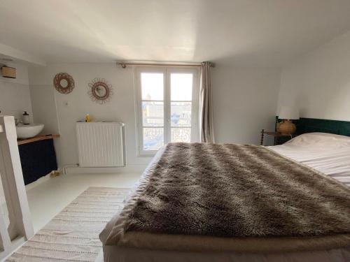 une chambre avec un grand lit et une fenêtre dans l'établissement Center next to castle and park, à Versailles