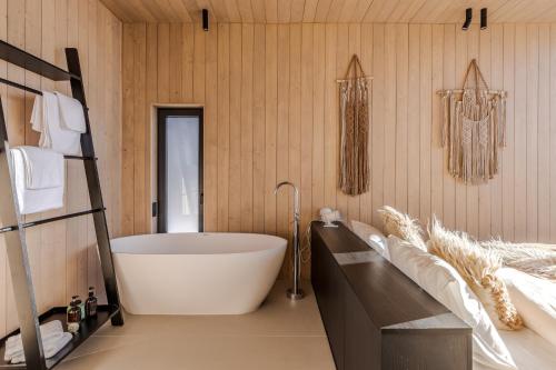 a bathroom with a large white tub in a room at Висота890 in Volosyanka