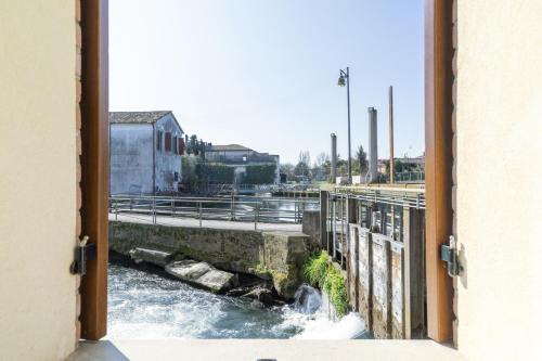 a view of a river from a window at Molino 2 by WelcHome in Treviso