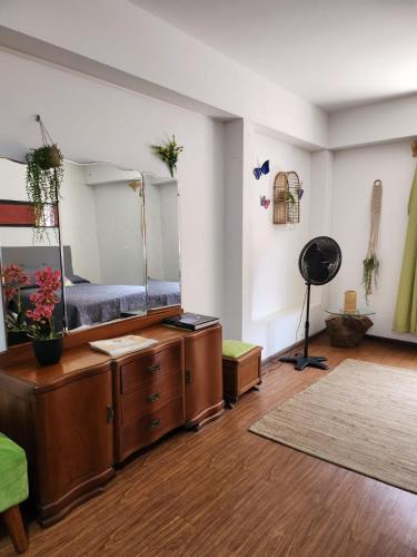 a room with a large mirror on top of a dresser at Alojamiento San Francisco - Apartamentos y habitaciones in Lima