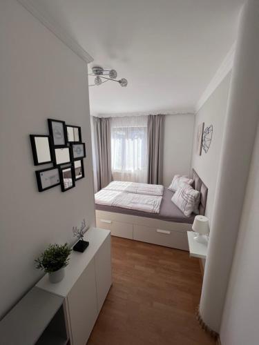 a small bedroom with a bed and a window at MaHome Apartments in Lofer
