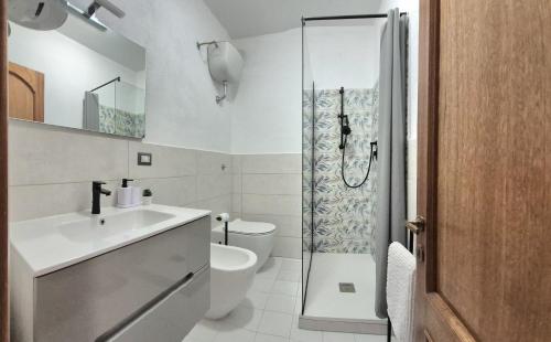 a bathroom with a toilet and a sink and a shower at Luce in Santa Maria Navarrese