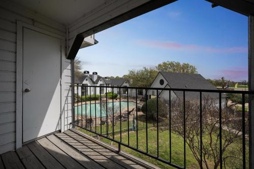 a balcony with a view of a pool at 3001 Crystal Springs 723 I Spacious 2 Bed 2 Bath in Bedford