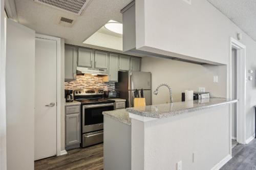 a kitchen with white cabinets and a stove top oven at 3001 Crystal Springs 723 I Spacious 2 Bed 2 Bath in Bedford