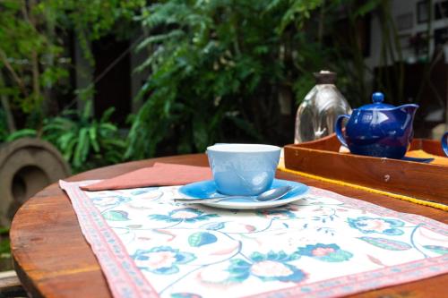 a blue cup and saucer on a table at The Fern Cove Villa - Colombo in Battaramulla
