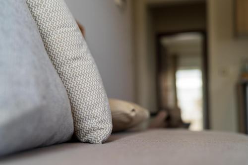 a teddy bear laying on a bed next to a pillow at Georgia's Garden by Omilos Hotels in Amoudara Herakliou