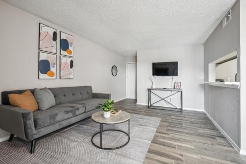 a living room with a couch and a table at 3001 Crystal Springs 922 I Spacious 1 Bed 1 Bath in Bedford
