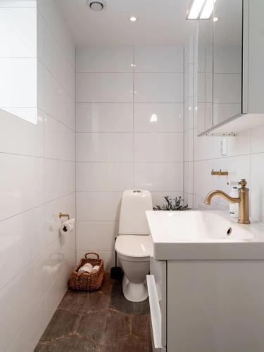 a white bathroom with a sink and a toilet at Ski lodge Åre by in Åre