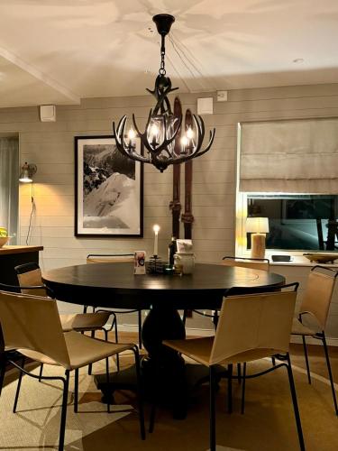 a dining room with a table and chairs and a chandelier at Ski lodge Åre by in Åre