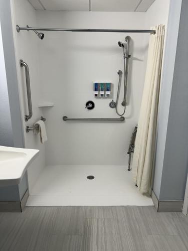 a white bathroom with a shower and a sink at Sandwich Lodge & Resort in Sandwich