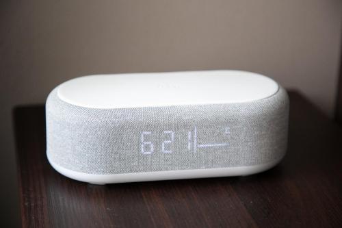 a white electronic device sitting on a wooden table at SPU Albergo 井高野 in Osaka