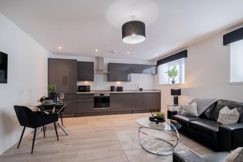a living room with a couch and a table at Union Row Retreat - SJA Stays - Luxury 1 Bed Apartment in Aberdeen