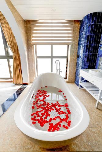 a bath tub filled with red hearts in a bathroom at LCV Mũi Né Resort in Mui Ne