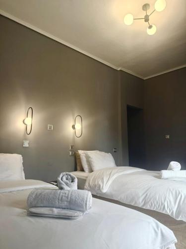 a bedroom with two beds with towels on them at ESPERIA Drama HOTEL in Drama