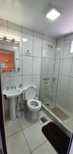 a bathroom with a toilet and a sink and a shower at Hospedaje Jose Gorgues in Puerto Iguazú