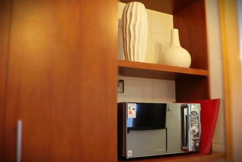 a kitchen with a small refrigerator in a cabinet at HOM I En Valle Cóndores II 4PAX con vista la Cordillera CV2402 in Farellones