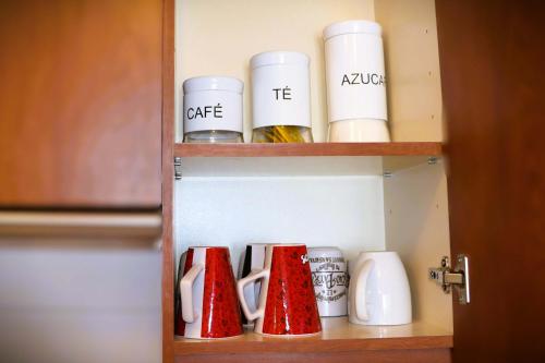 a cupboard with a bunch of cups in it at HOM I En Valle Cóndores II 4PAX con vista la Cordillera CV2402 in Farellones