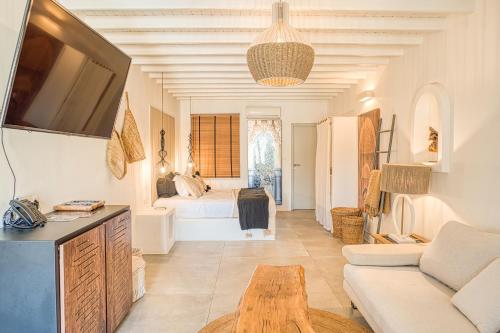 a living room with a couch and a tv at Santa Maria Hotel in Elia Beach