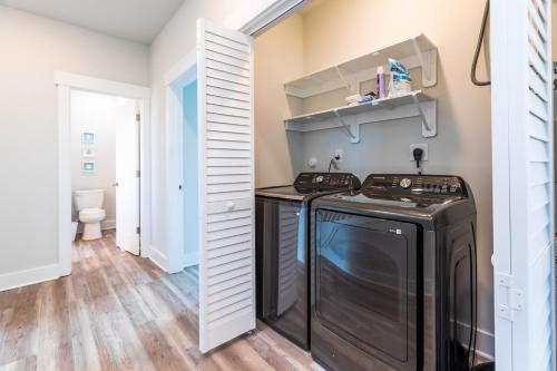 a laundry room with a washer and dryer at Stunning Sunset, Close To Beach Access, Great Views! in Surf City