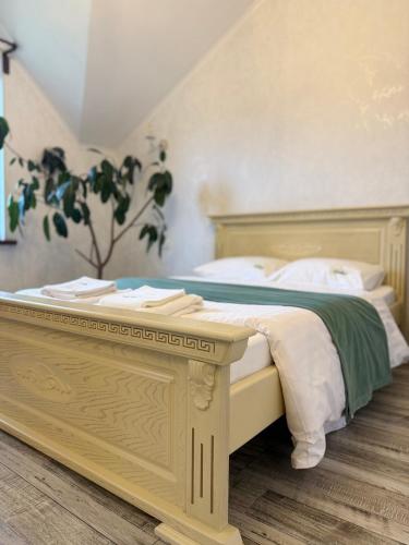 a bedroom with a large bed with a table at Мелодія Гір .Апартаменти з видом на гори . in Vorokhta