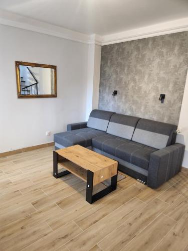 a living room with a couch and a coffee table at Willa Park in Ostrowiec Świętokrzyski