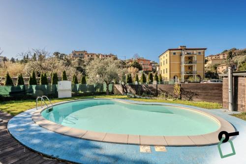 a large swimming pool in the middle of a yard at HOTIDAY Apartment Collection - Lerici Terrediliguria in Lerici