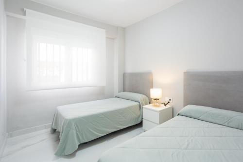 Katil atau katil-katil dalam bilik di Apartamento grande xeraco playa