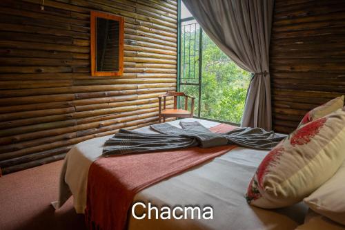a bed in a room with a window and towels on it at Thabela Thabeng in Parys