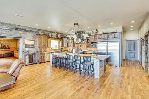 an open kitchen and living room with wood floors and a large island at Riverside Retreat in Bridgeport with Game Room! in Bridgeport