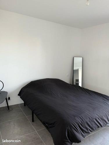 - une chambre avec un lit noir et un miroir dans l'établissement Maison de vacances avec piscine, à Cabestany