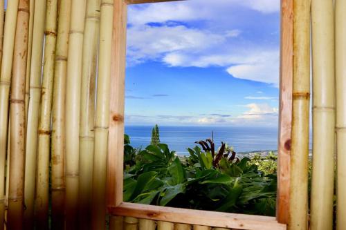 a view of the ocean from a bamboo window at Kailua Kona Overlook Suites in Kailua-Kona