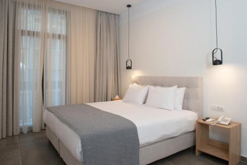 Postel nebo postele na pokoji v ubytování Evia Hotel