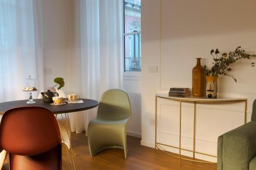 a room with a table and two chairs and a table at Elysium Boutique Apartments - Catania in Catania