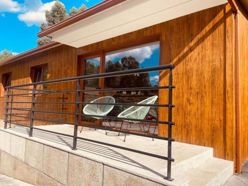 a house with two chairs on a balcony at Chalé da Boucinha in Celorico de Basto