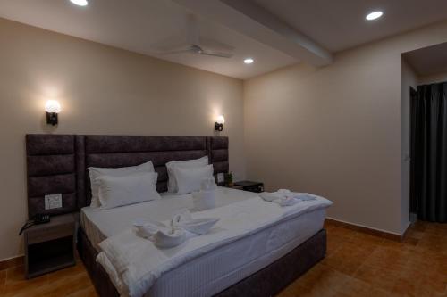 a bedroom with a large bed with two bowls on it at Evoke Express Candolim in Candolim