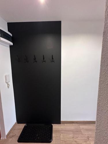a black wall with a black keyboard in a room at Apartmán Luxe Brezno center in Brezno