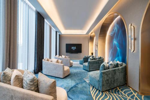 a living room with couches and a flat screen tv at Meliá Pattaya Hotel in Pattaya Central