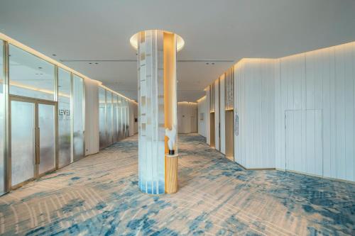 a corridor of a building with a column in the middle at Meliá Pattaya Hotel in Pattaya Central