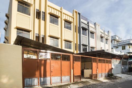an apartment building with orange and yellow doors at Hotel O Kost Ketapang Syariah in Medan