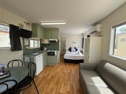 a small apartment with a kitchen and a living room at Hay Caravan Park in Hay