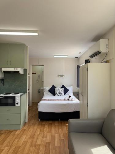 a small room with a bed and a kitchen at Hay Caravan Park in Hay