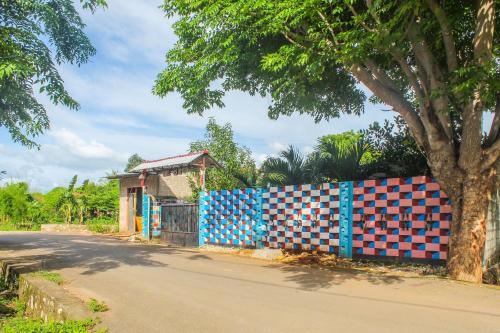 a colorful fence on the side of a street at Hotel O We Bro Kost in Kupang