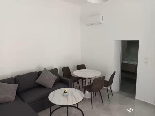 a living room with a couch and chairs and tables at The Sun House in Paradisi in Rhodes Town
