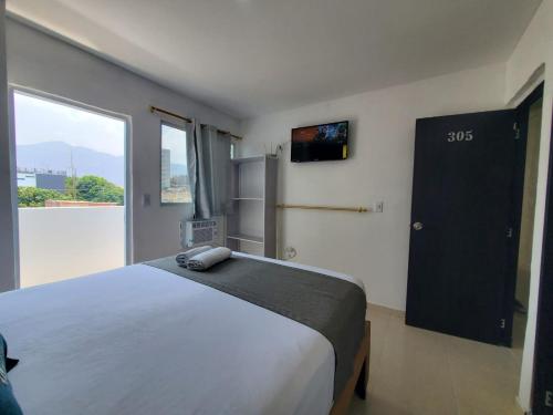 Ένα ή περισσότερα κρεβάτια σε δωμάτιο στο Apartahotel hm caribe