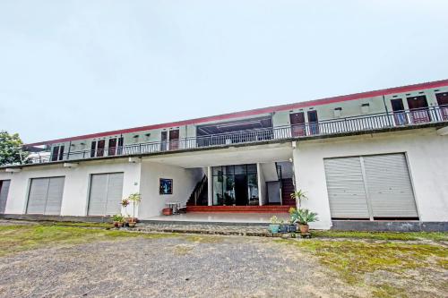 a large white building with a lot of windows at Hotel O Panorama Rinjani LodgeNearTaman Nasional Gunung Rinjani in Labuan Lombok