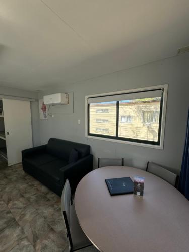 a living room with a table and a couch at Hay Caravan Park in Hay
