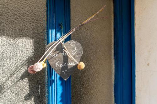 a heart hanging on a wall with knitting needles at Gite du Canal in Josselin