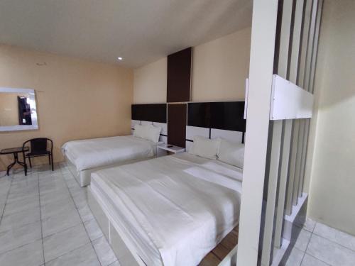 Postel nebo postele na pokoji v ubytování Hotel O Subur