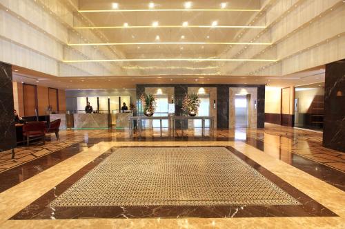 a lobby with a large pool in the middle of it at Radisson Blu Hotel Chennai City Centre in Chennai